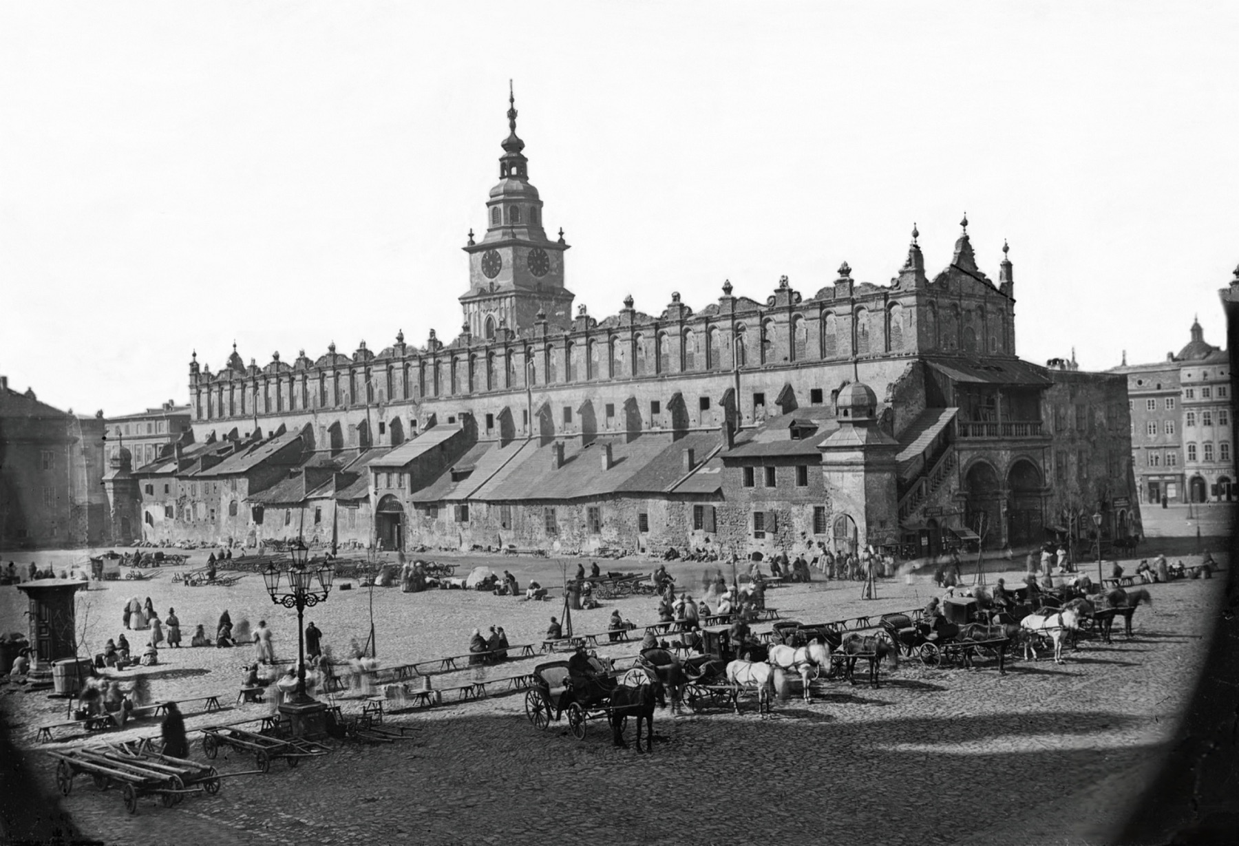 The Main Market Square in Kraków in 1872: the Cloth Hall still with its annexes, market stalls and cobbles in front.